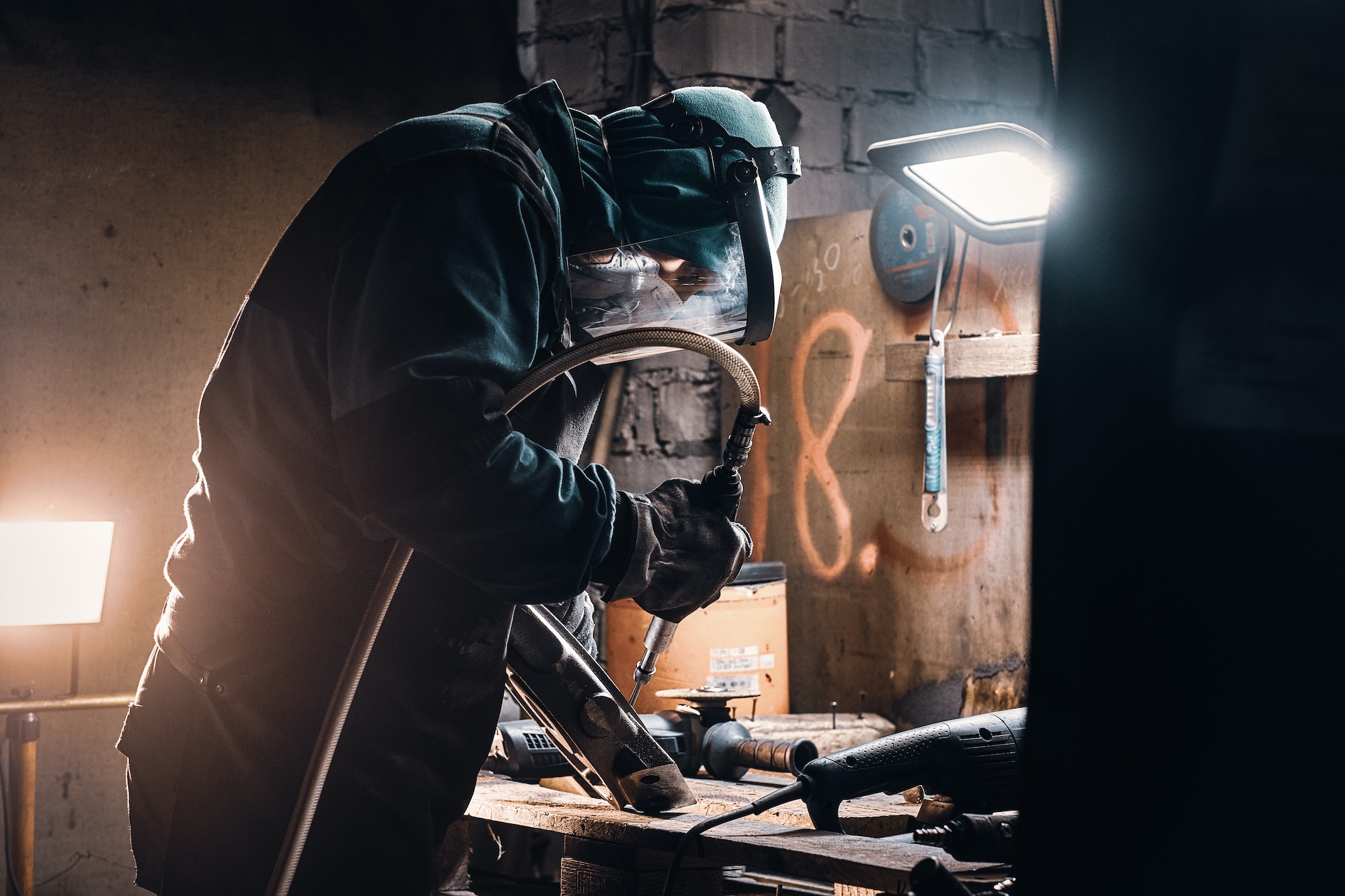Busy man is working on metal factory