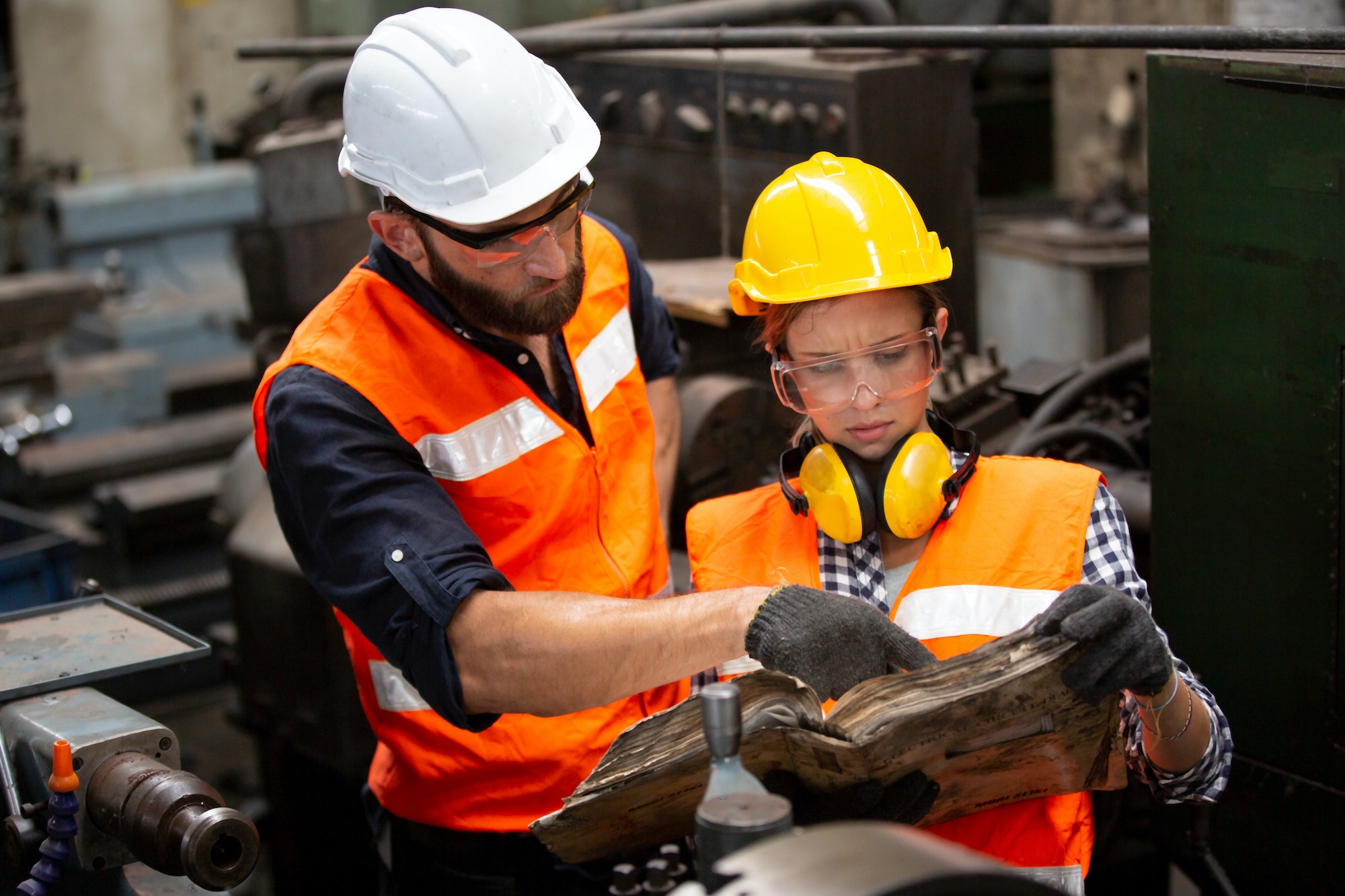 Portrait woman worker and engineer under inspection and checking production process on factory.